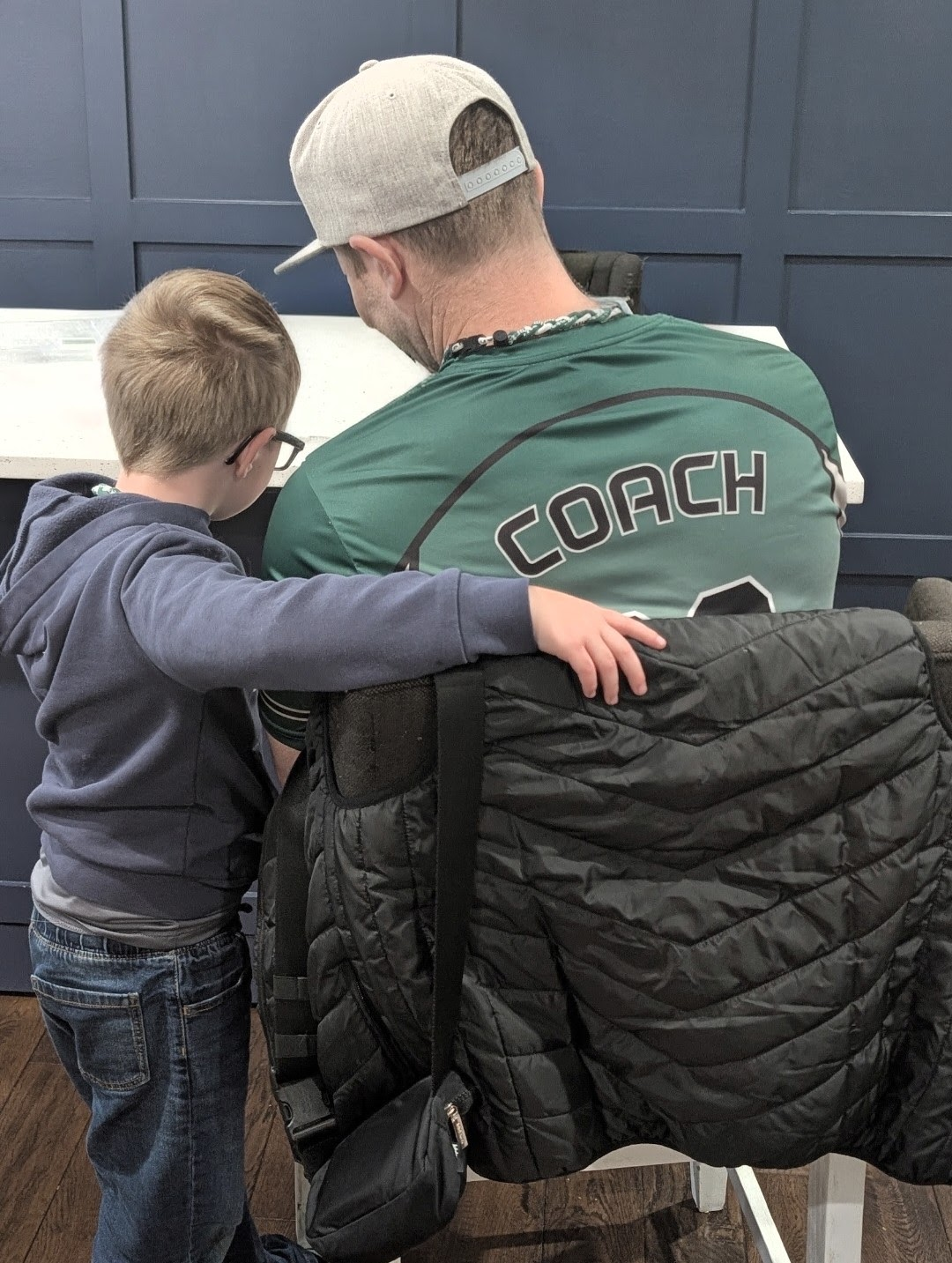 Chase Sonen in a coach jersey with Nolan — authentic family photo